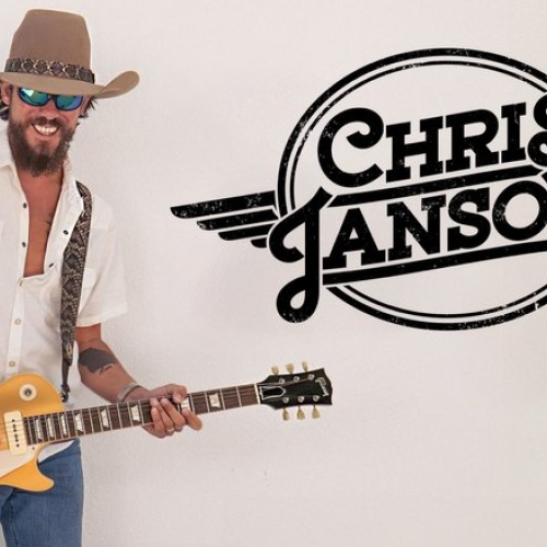 A person with a guitar wearing a hat and sunglasses, next to a 
